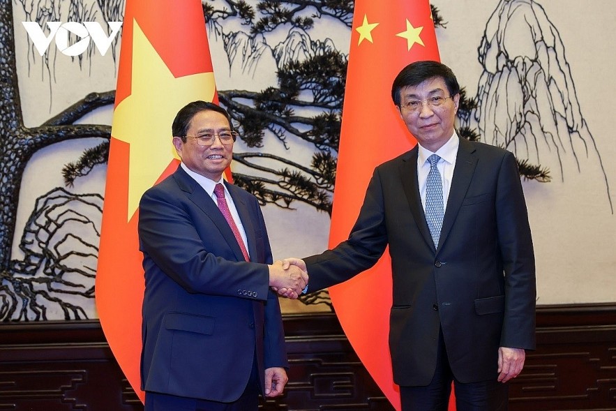 Vietnamese Prime Minister Pham Minh Chinh (R) meets with chairman of the National Committee of the Chinese People's Political Consultative Conference (CPPCC), Wang Huning.