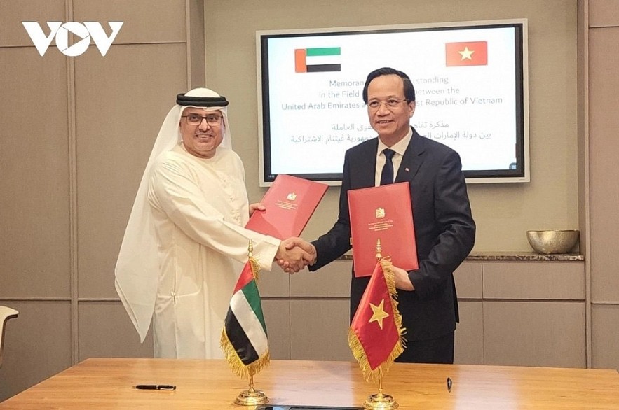 Vietnamese Minister of Labour, Invalids and Social Affairs Dao Ngoc Dung and UAE Minister of Human Resources and Emiratisation Abdulrahman Al-Awar exchange the signed document on human resources cooperation between the two countries, following the signing ceremony in Dubai on December 1, 2023 Vietnamese Minister of Labour, Invalids and Social Affairs Dao Ngoc Dung and UAE Minister of Human Resources and Emiratisation Abdulrahman Al-Awar exchange the signed document on human resources cooperation between the two countries, following the signing ceremony in Dubai on December 1, 2023