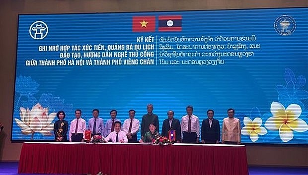 At a conference to promote cooperation between businesses of Hanoi and Vientiane in Laos in March 2024. (Photo: VNA) At a conference to promote cooperation between businesses of Hanoi and Vientiane in Laos in March 2024. (Photo: VNA)
