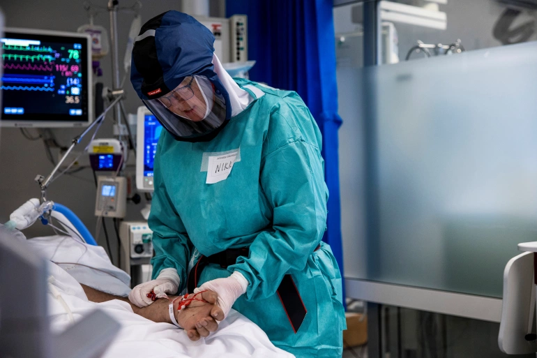 A COVID-19 patient is treated in the intensive care unit at Oslo University Hospital [File: NTB/Jil Yngland via Reuters]