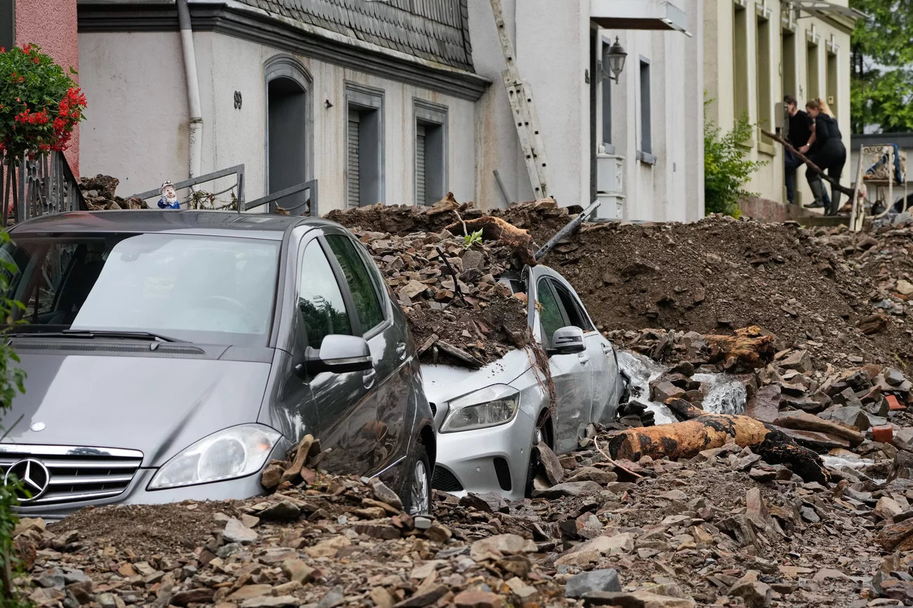 Cars are covered with debris brought on by flooding from a nearby river on Thursday in Hagen, Germany. Martin Meissner/AP Cars are covered with debris brought on by flooding from a nearby river on Thursday in Hagen, Germany. Martin Meissner/AP