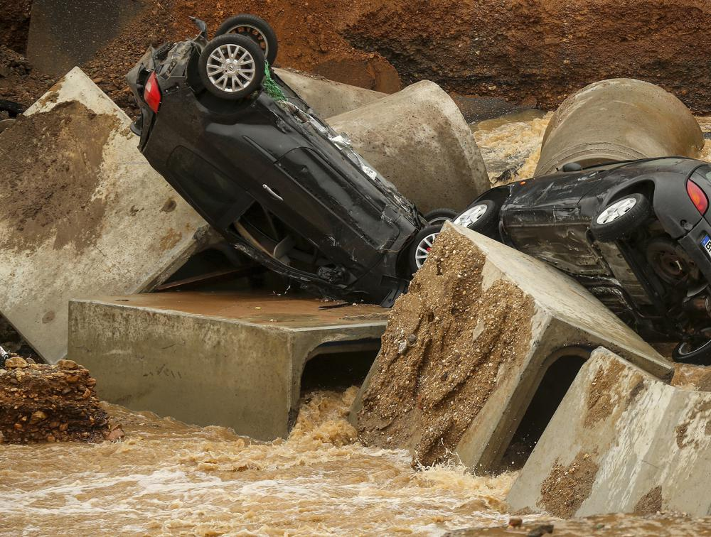 Cars lie in a washed out part of the Bessem district of Erftstadt, Germany, Friday, July 16, 2021. Photo: AP Cars lie in a washed out part of the Bessem district of Erftstadt, Germany, Friday, July 16, 2021. Photo: AP