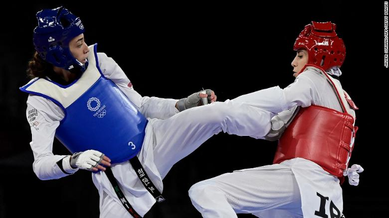 Refugee Olympic Team's Kimia Alizadeh (Blue) and Iran's Nahid Kiyani Chandeh (Red) compete in the taekwondo women's -57kg elimination round bout during the Tokyo 2020 Olympic Games at the Makuhari Messe Hall in Tokyo on July 25, 2021. Photo: CNN Refugee Olympic Team's Kimia Alizadeh (Blue) and Iran's Nahid Kiyani Chandeh (Red) compete in the taekwondo women's -57kg elimination round bout during the Tokyo 2020 Olympic Games at the Makuhari Messe Hall in Tokyo on July 25, 2021. Photo: CNN