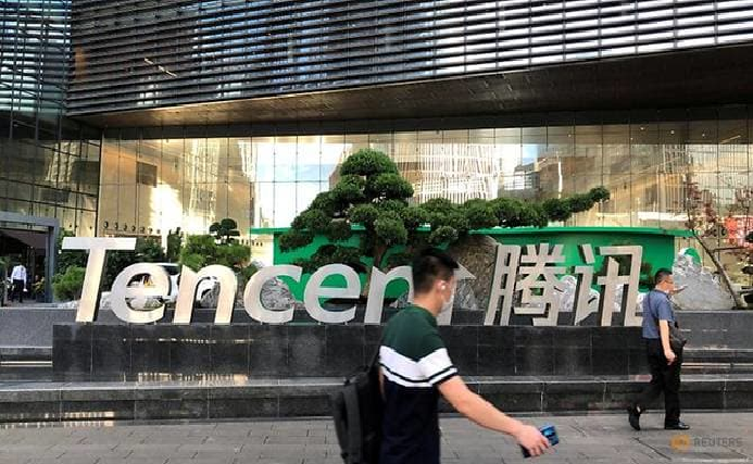 FILE PHOTO: People walk past a Tencent sign at the company headquarters in Shenzhen, Guangdong province, China August 7, 2020. REUTERS/David Kirton 2038 tencent 2