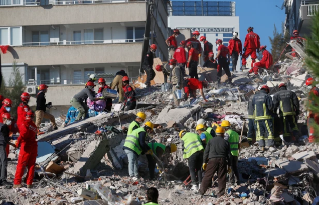 Members of rescue services search for survivors in the debris of a collapsed building in Izmir, Turkey, today.Darko Bandic/AP 1646 turkey