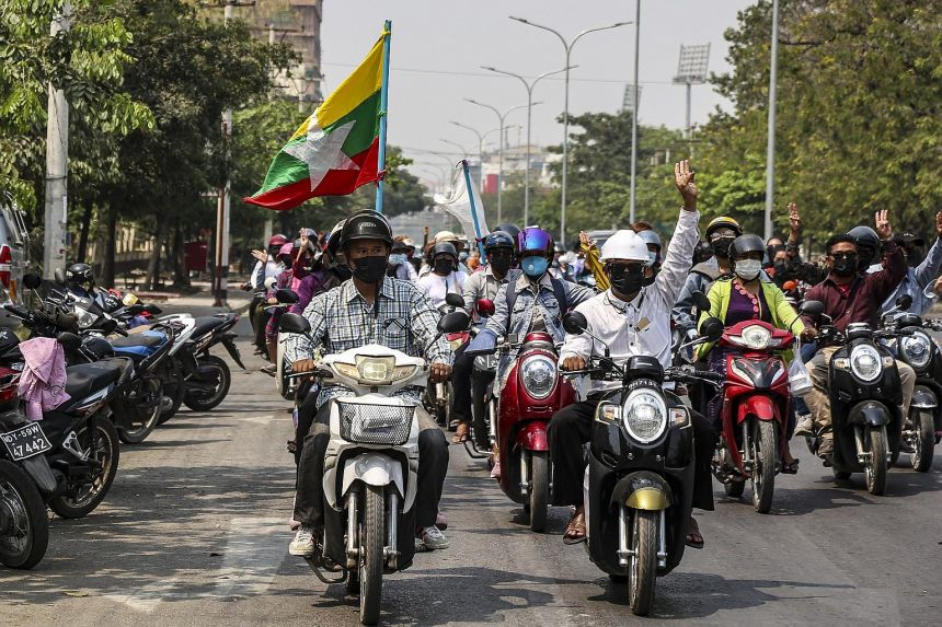 People on motorcycles flashing a three-finger salute, a symbol of the protest movement, during a demonstration yesterday against the military coup in Mandalay. Many people in Myanmar see China as supportive of the coup.PHOTO: EPA-EFE 4915-my1