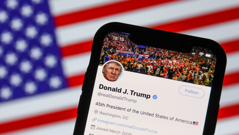 Twitter feed of the President of the USA Donald Trump is seen displayed on a phone screen with American flag in the background in this illustration photo taken on August 2, 2020. President of the USA Donald Trump said that Chinese app TikTok will be. Photo by 3846 trump1