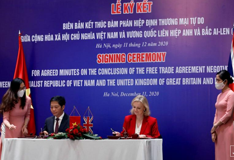 Britain's International Trade Secretary Liz Truss and Vietnam's Minister of Industry and Trade Tran Tuan Anh sign an agreement which will pave the way to a free trade deal, in Hanoi, Vietnam December 11, 2020. 1334 uk1