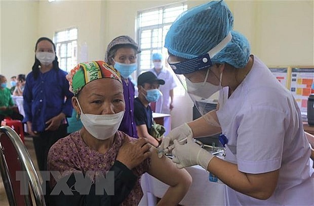 A woman gets vaccinated against Covid-19. Photo: VNA A woman gets vaccinated against Covid-19. Photo: VNA